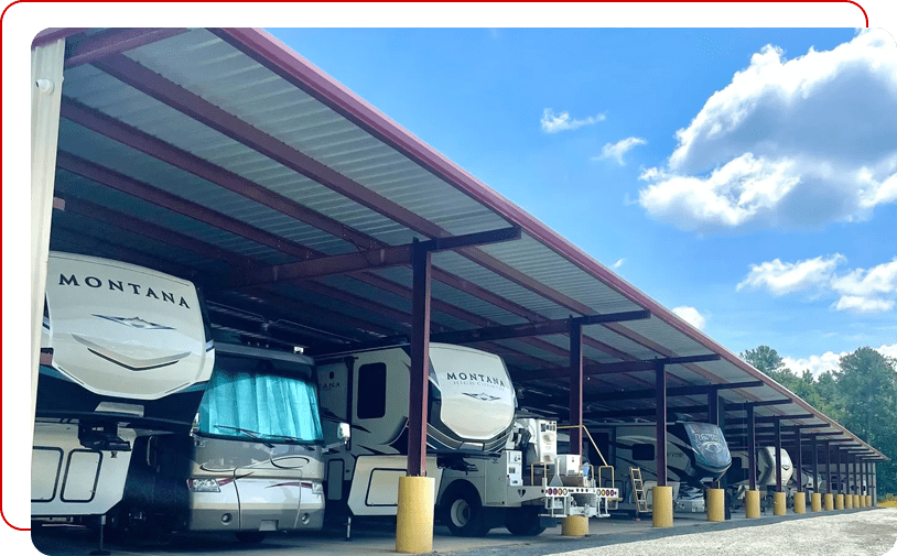 A row of recreational vehicles parked in a covered parking lot.