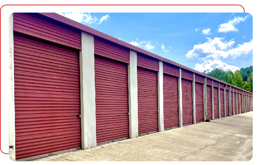 A red garage door is shown on the side of a building.