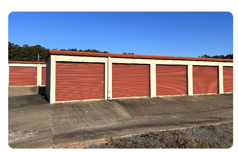 A row of three red and white garages.